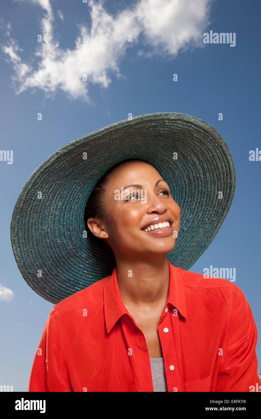 Portrait of smiling woman wearing straw hat Stock Photo - Alamy