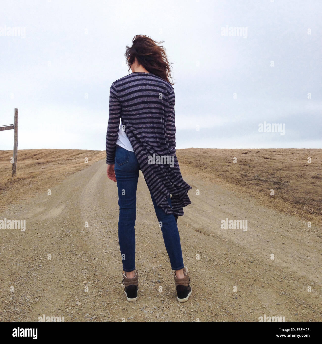Rear view of a Woman standing in a road Stock Photo - Alamy