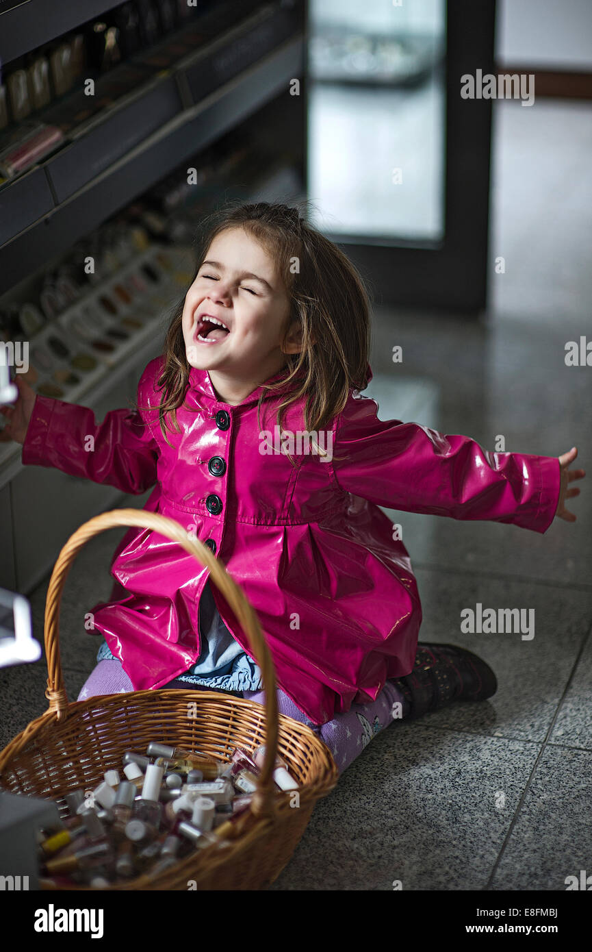 Little girl (45) screaming by basket of cosmetics Stock Photo Alamy