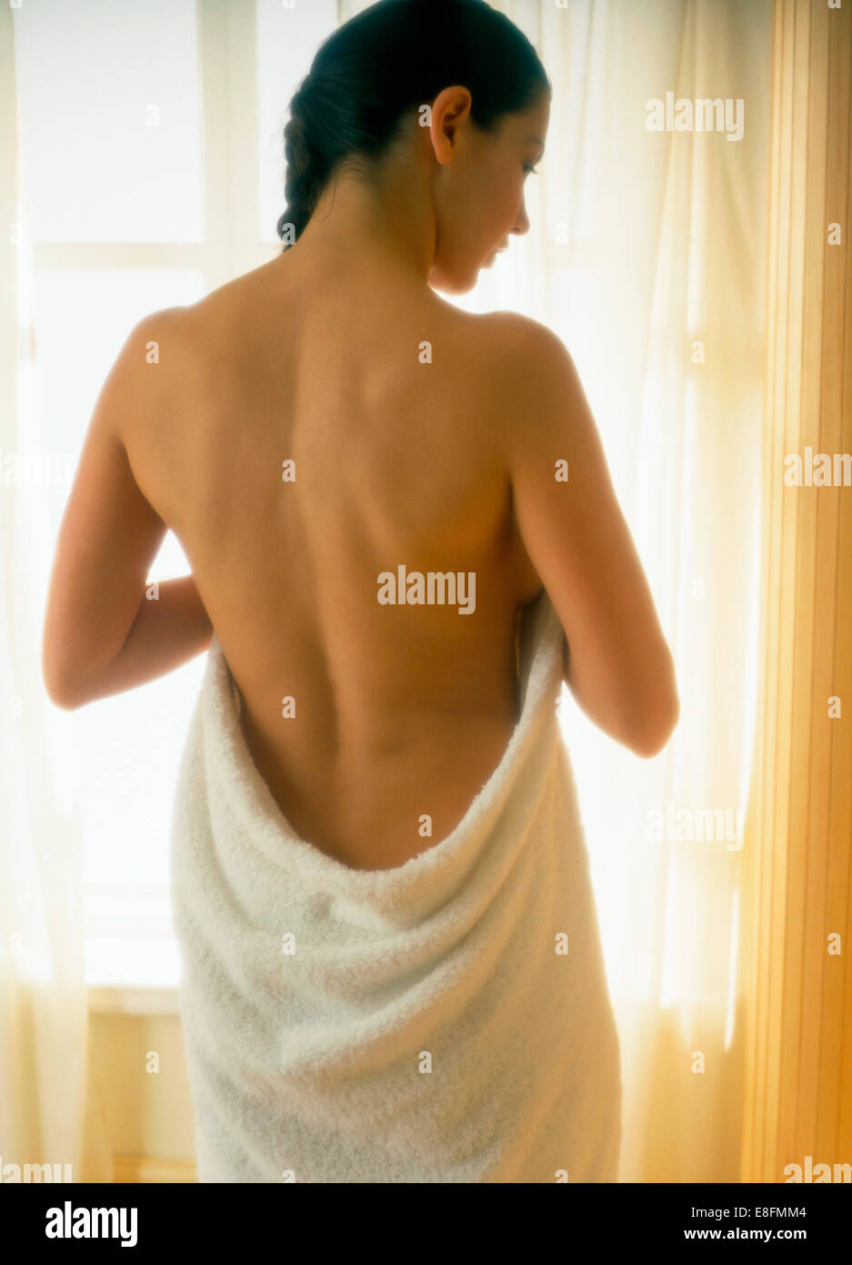 Rear view of woman Woman wrapped in towel Stock Photo