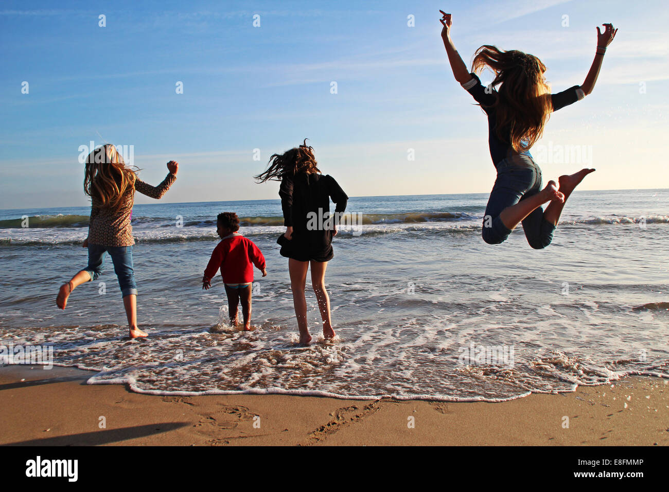 Four girls messing about on the beach, Barcelona, Spain Stock Photo Alamy