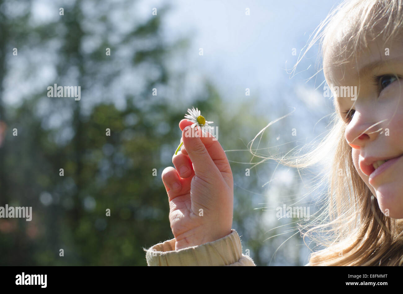 Portrait of a girl holding daisy flower Stock Photo