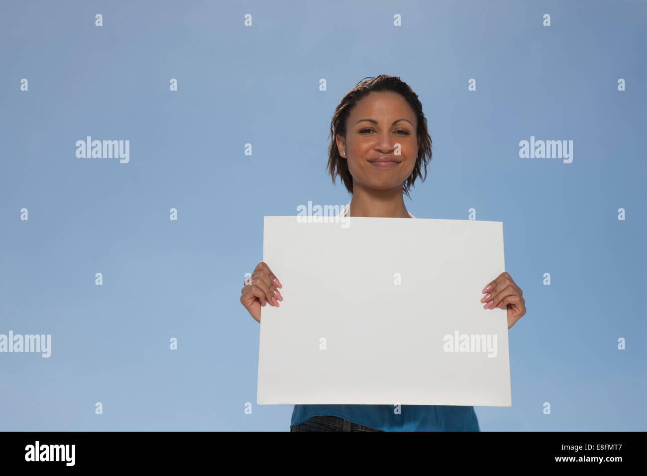 Woman holding up blank sign hi-res stock photography and images - Alamy