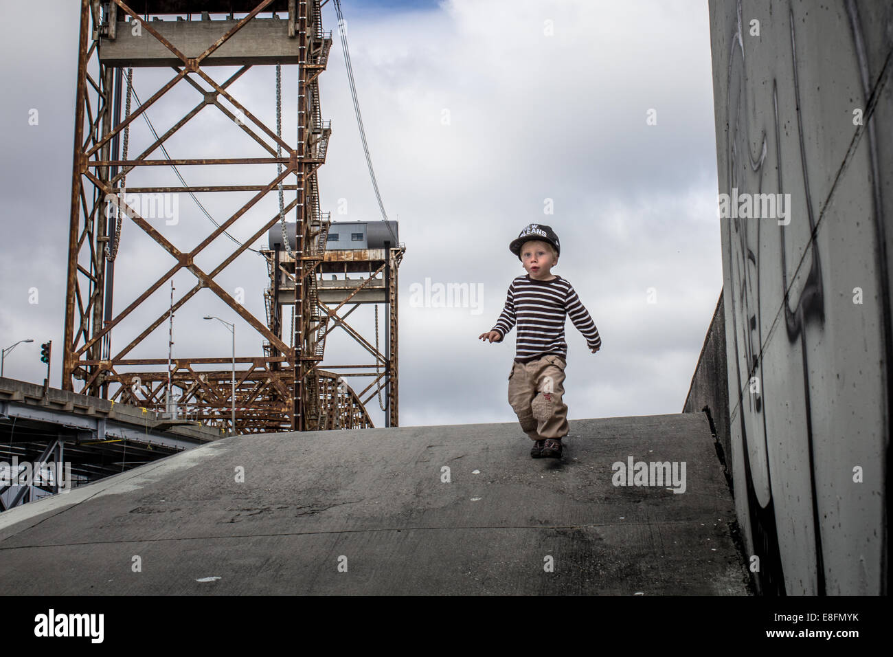 Boy running down from levee in Lower ninth ward, New Orleans, Louisiana, United States Stock Photo