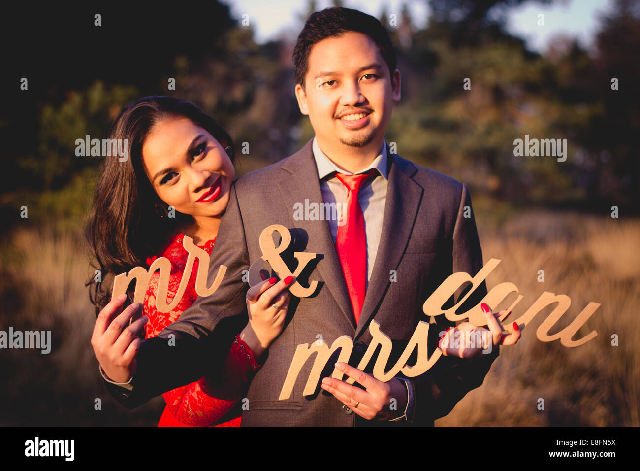 Netherlands, Portrait of couple holding cut out letters Stock Photo