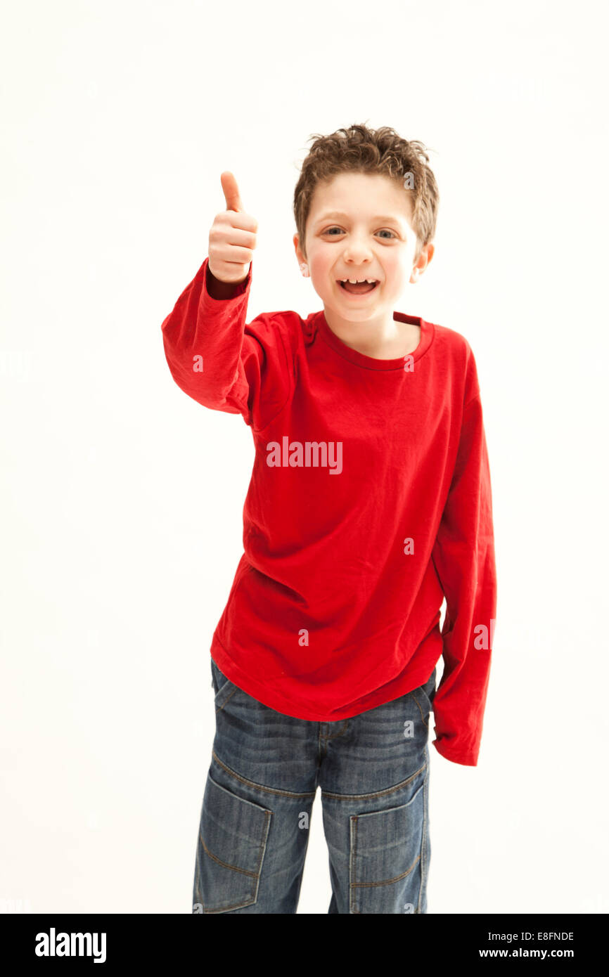 Portrait of a smiling boy giving a thumbs up gesture Stock Photo - Alamy