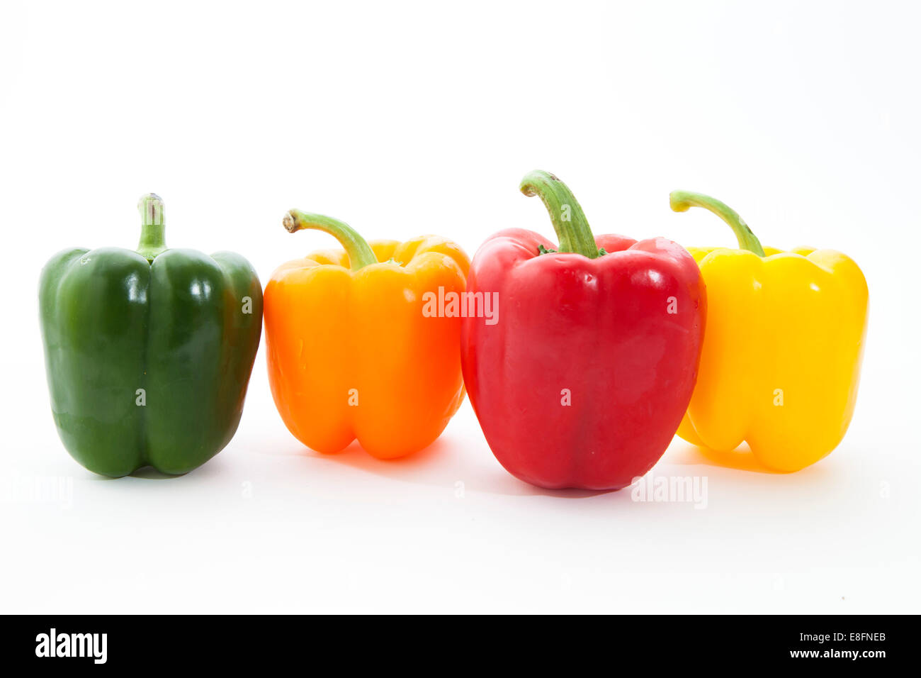 Multi-colored Bell Peppers in a row Stock Photo