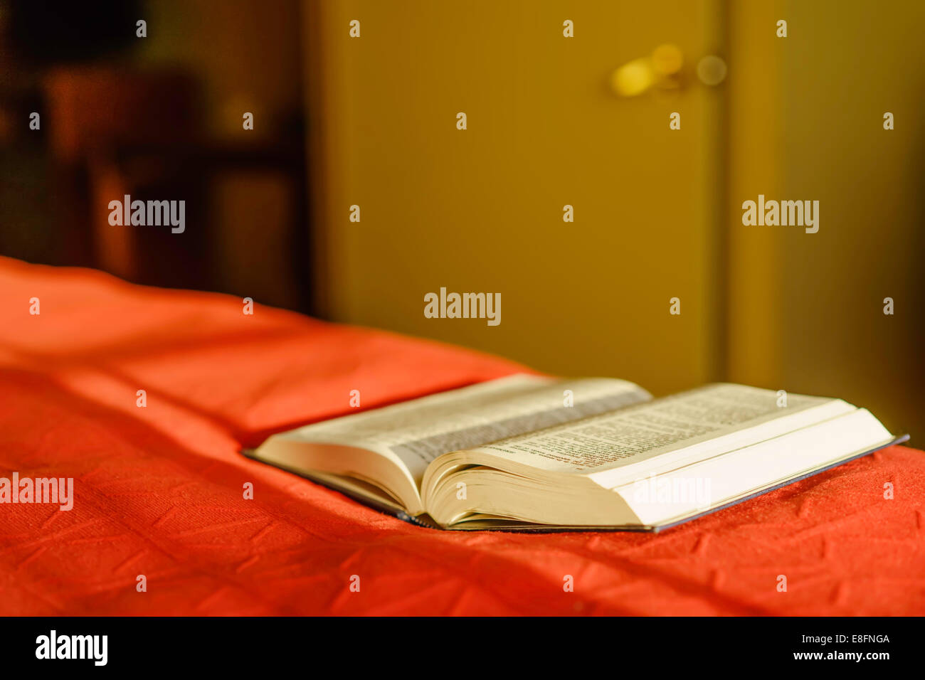 Open Bible lying on the edge of a bed Stock Photo - Alamy