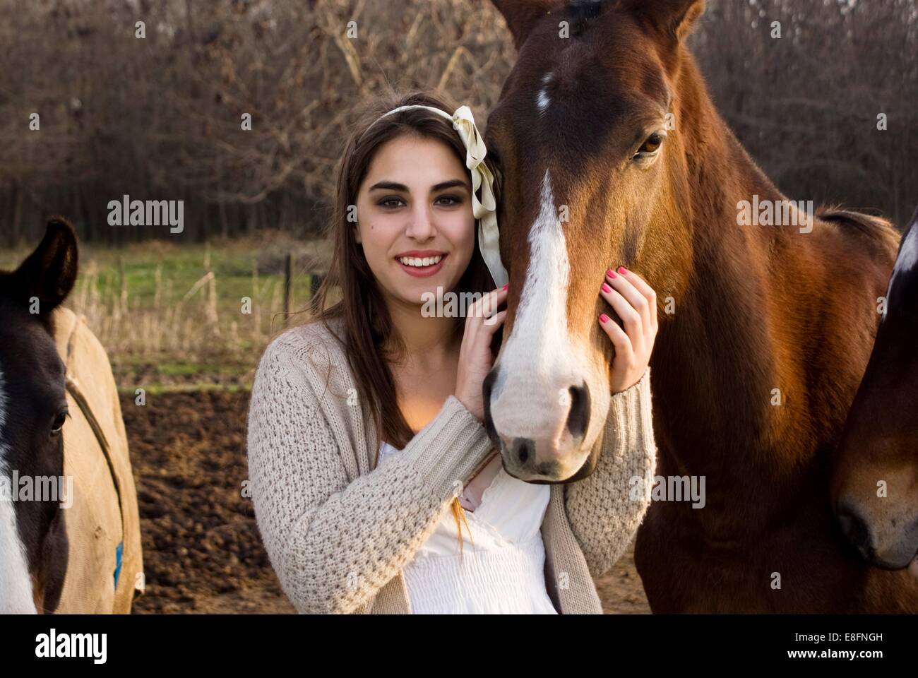 Argentina, Buenos Aires, Partido del Pilar, Manzanares, Portrait of teen (14-15) girl stroking horse Stock Photo