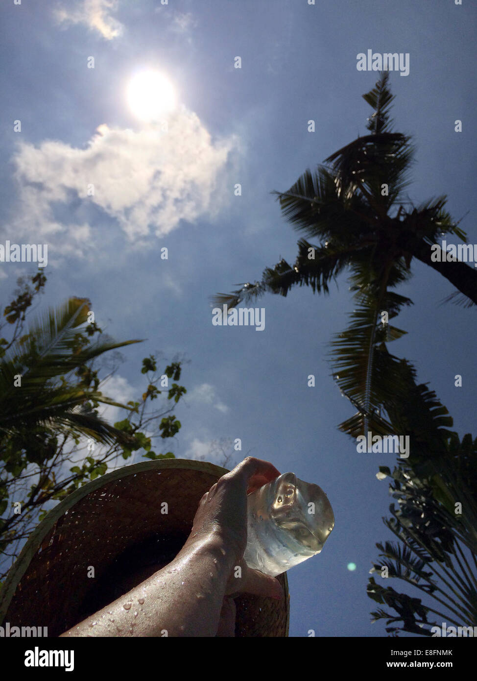 Woman drinking water in hot weather Stock Photo