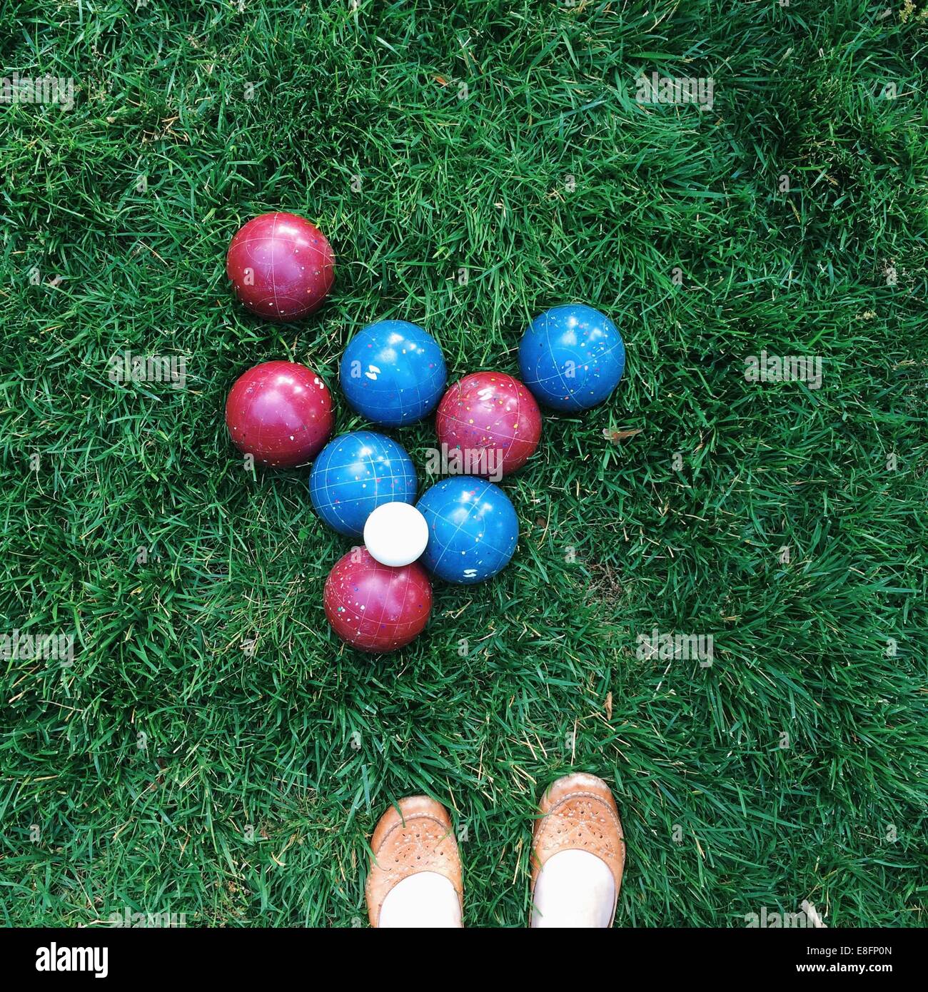 Bocce balls on green grass in park with woman's shoes Stock Photo Alamy