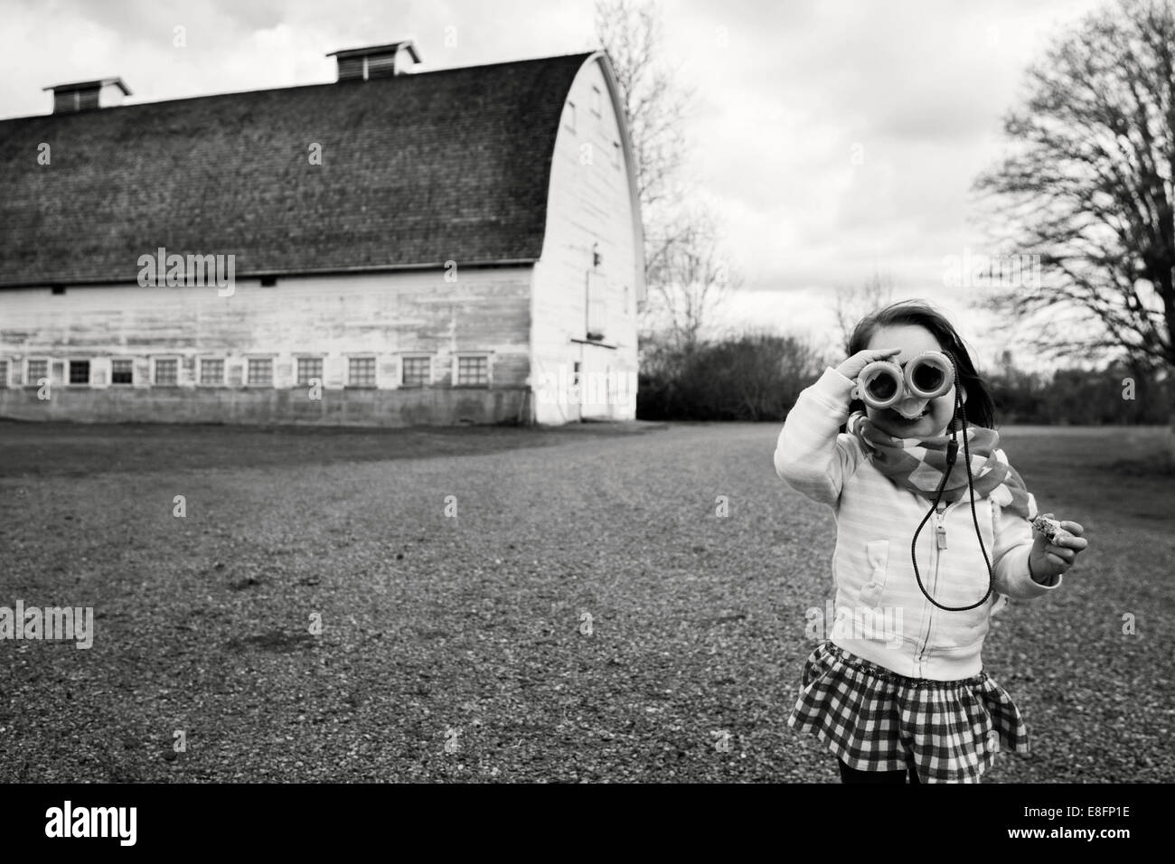 Girl looking through binoculars, USA Stock Photo