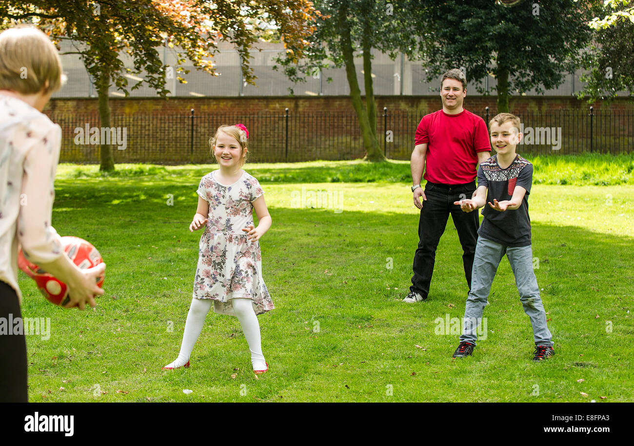 UK, West Midlands, Family with children (8-9), (10-11) ball game Stock Photo