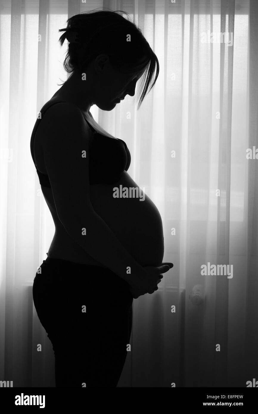Silhouette of pregnant woman Stock Photo - Alamy