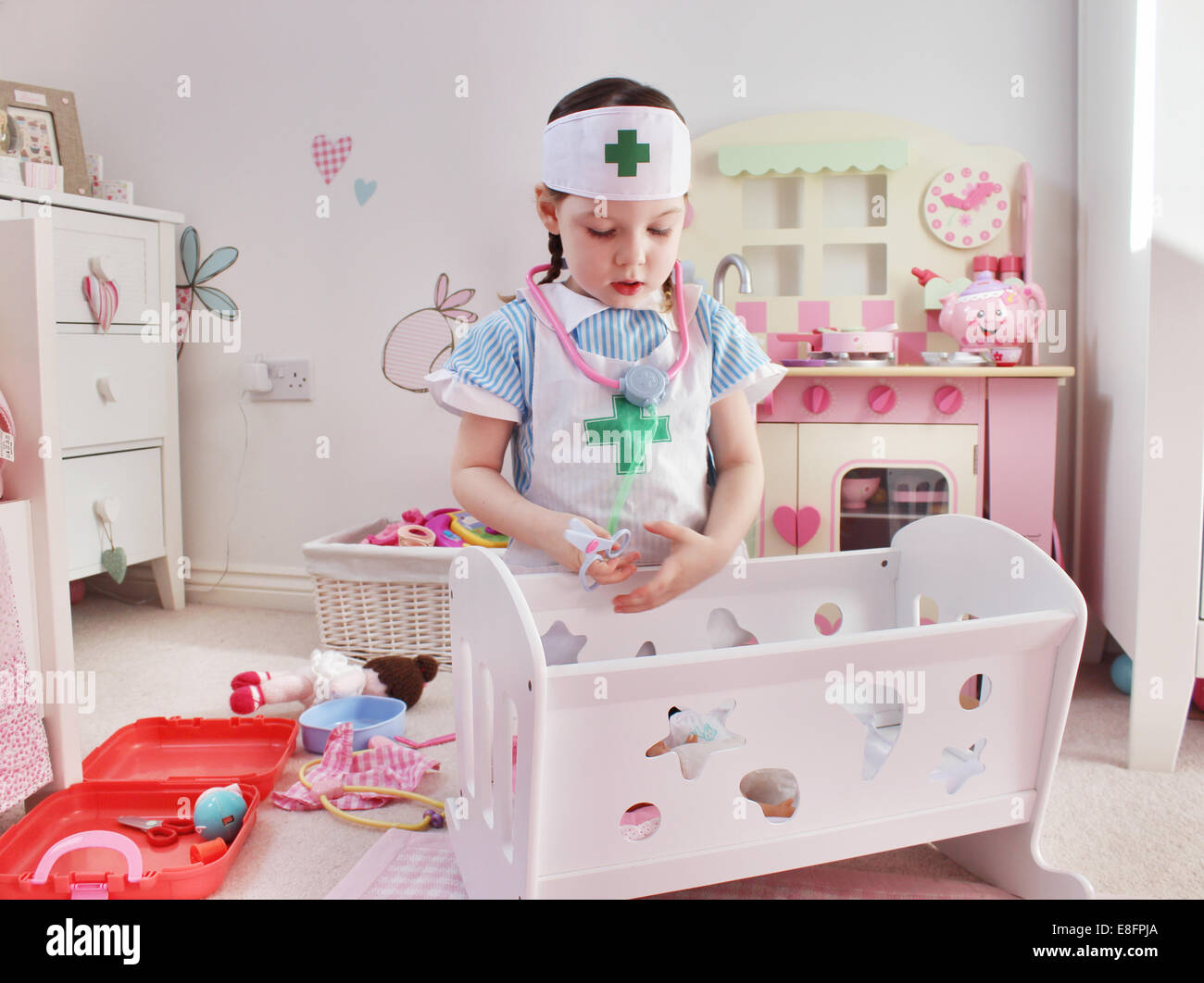 Girl dressed as a nurse playing Stock Photo - Alamy