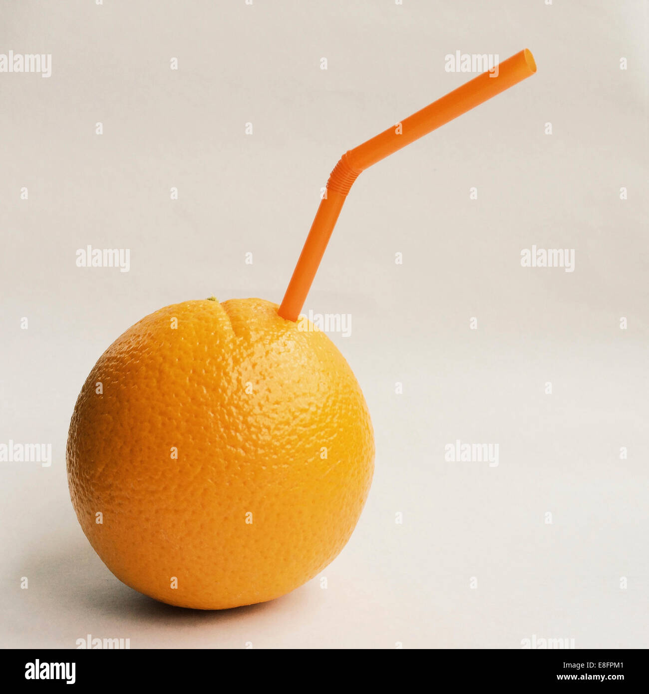 Orange with straw Stock Photo