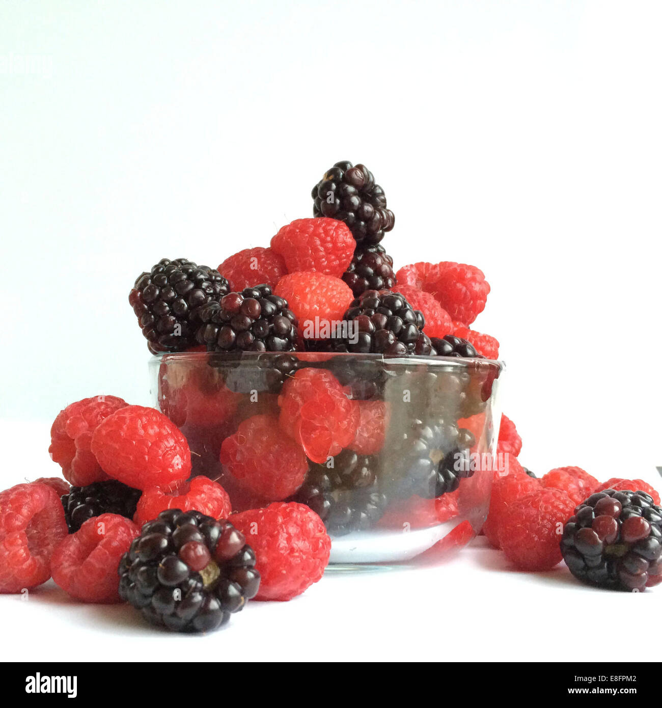Glass bowl of raspberries and blackberries Stock Photo