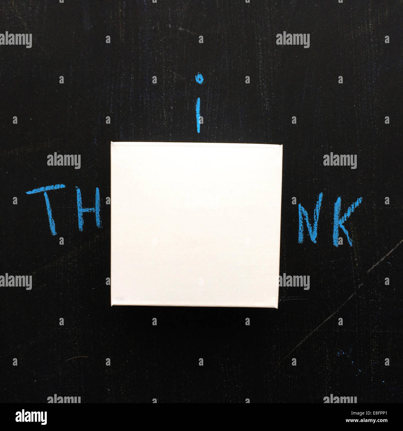 Blank adhesive note on blackboard with the word THINK Stock Photo