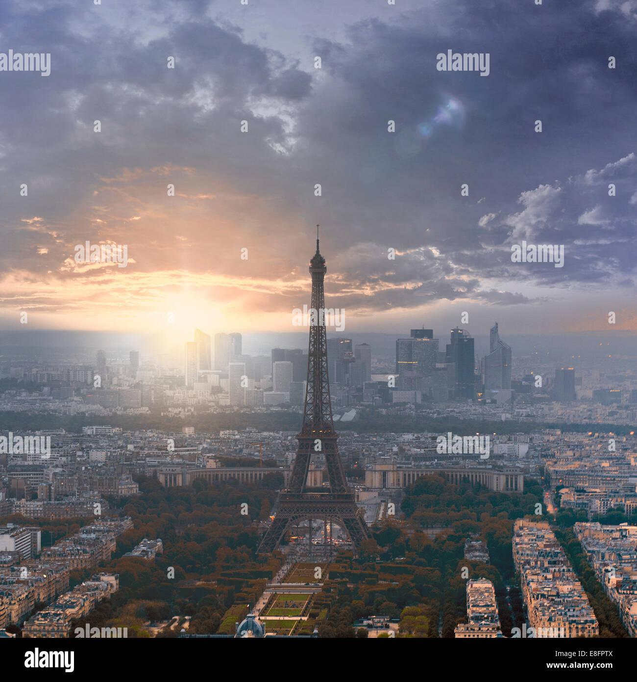 Eiffel Tower at sunset with La Defense in the distance, Paris, France Stock Photo