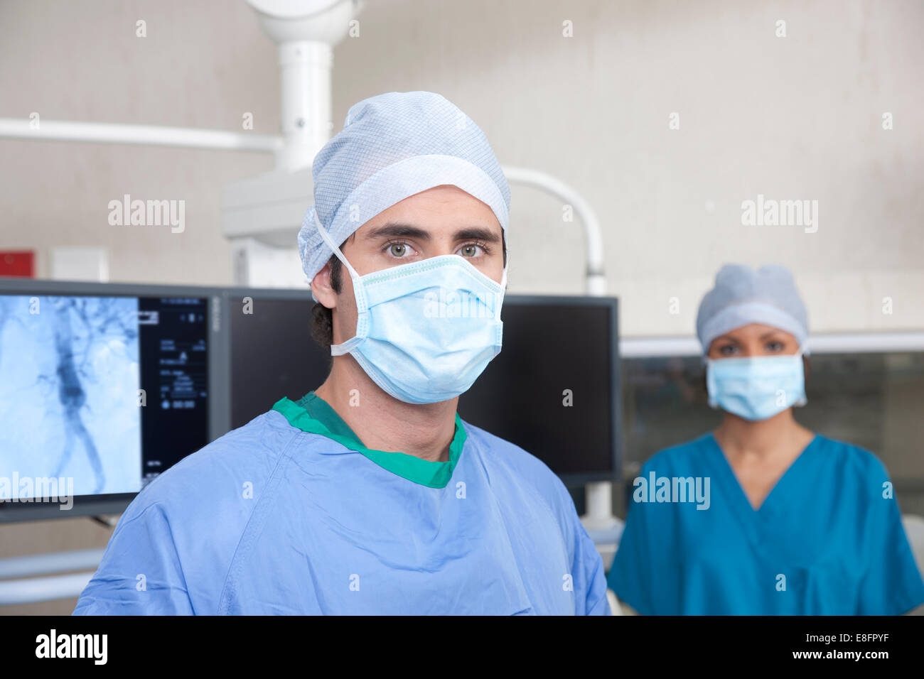 Two doctors standing in operating theatre Stock Photo
