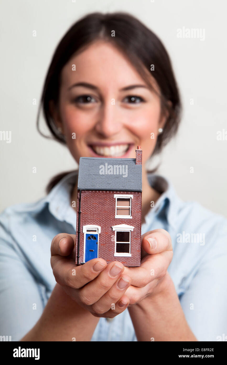 Young woman holding model house Stock Photo