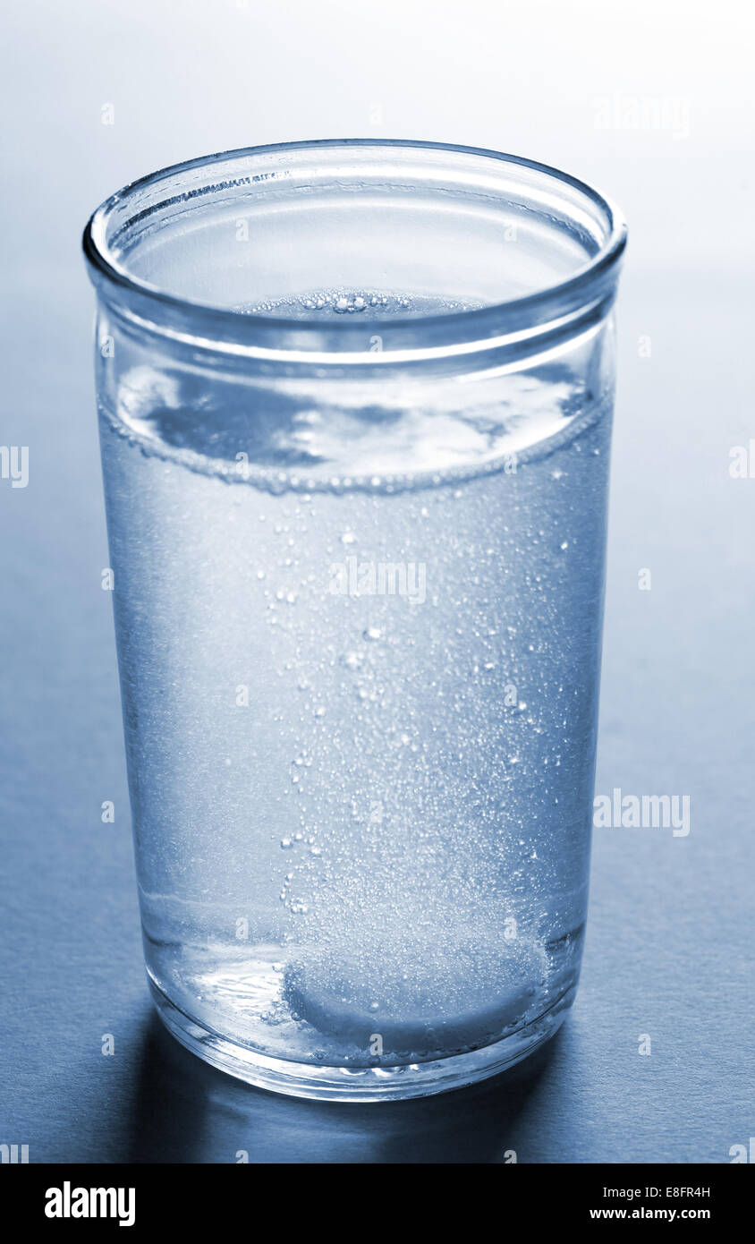 Pill dissolving in glass of water Stock Photo