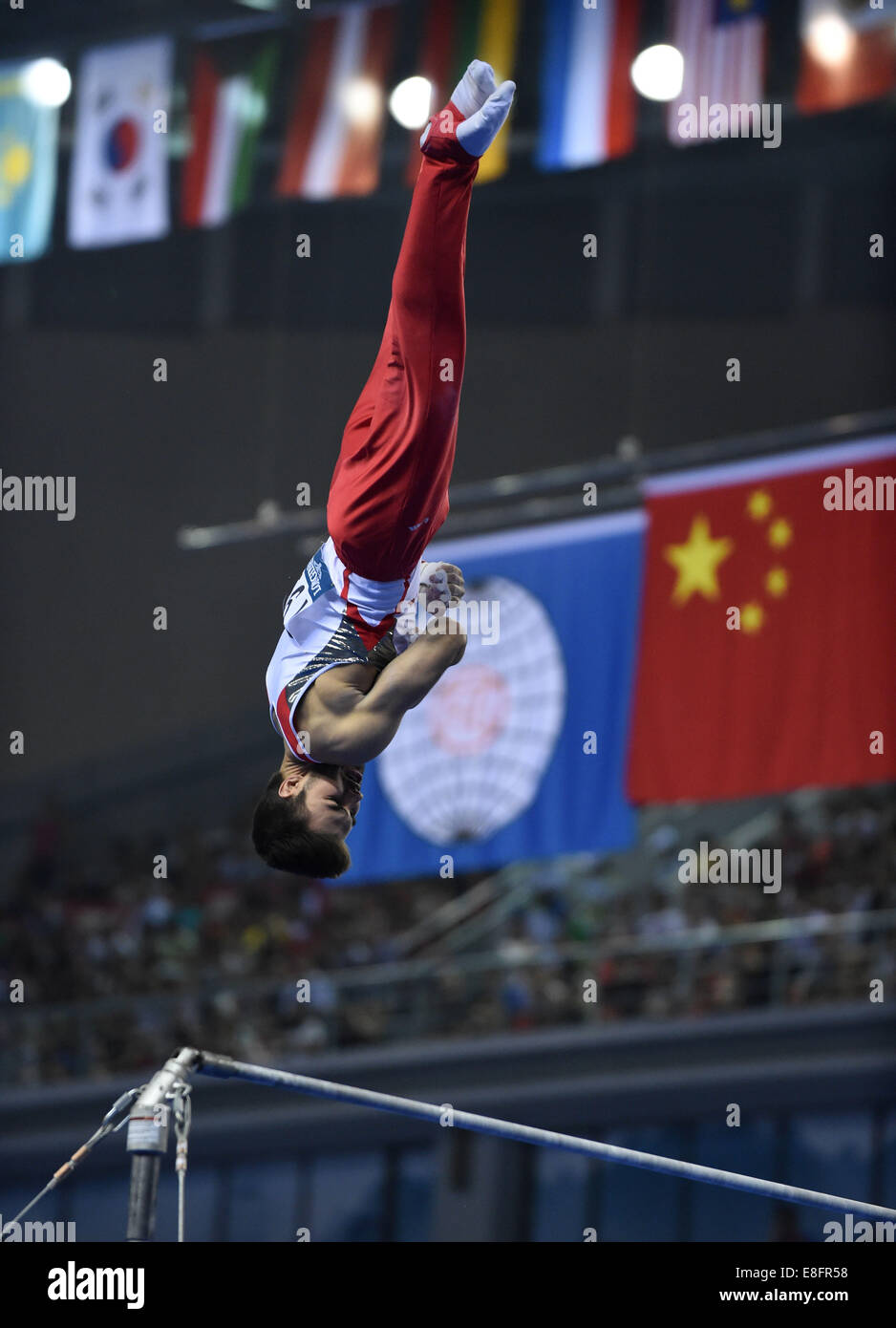 Nanning, China's Guangxi Zhuang Autonomous Region. 7th Oct, 2014. Oliver Hegi of Switzerland performs on the horizontal bar during the men's team finals of the 45th Gymnastics World Championships in Nanning, capital of south China's Guangxi Zhuang Autonomous Region, Oct. 7, 2014. Stock Photo