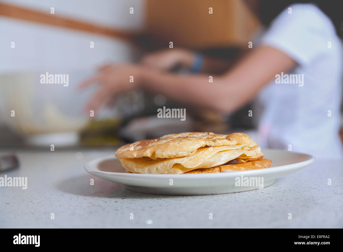 Girl cooking pancakes in kitchen Stock Photo Alamy