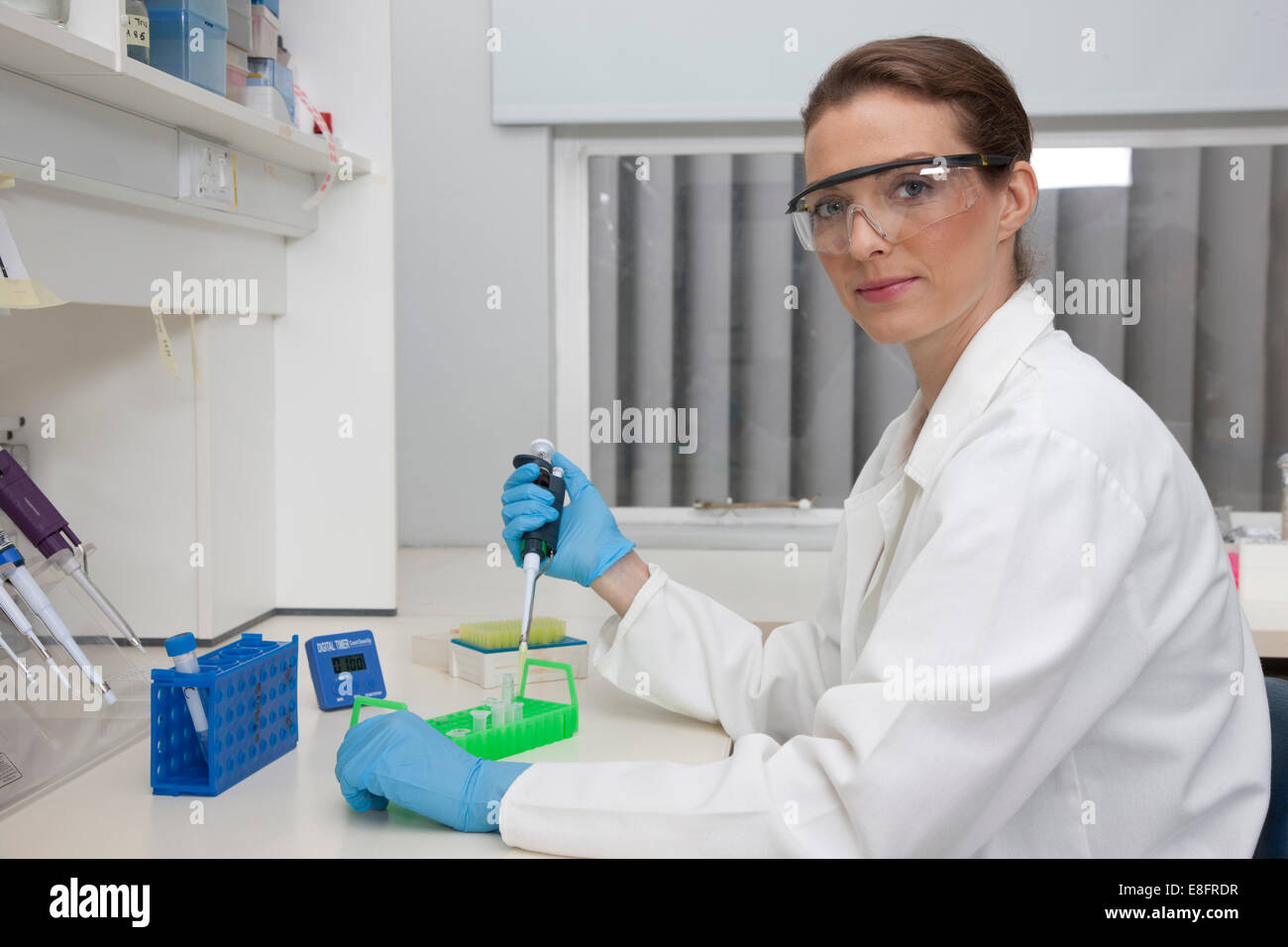 Lab technician pipetting samples in research laboratory Stock Photo
