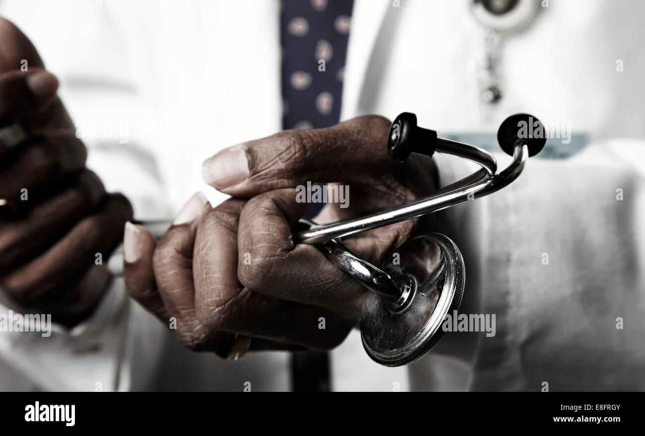 Doctor holding stethoscope Stock Photo