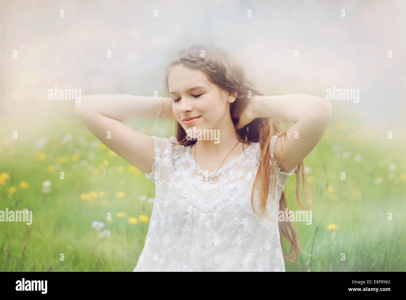 Portrait of a beautiful girl standing in a meadow Stock Photo - Alamy