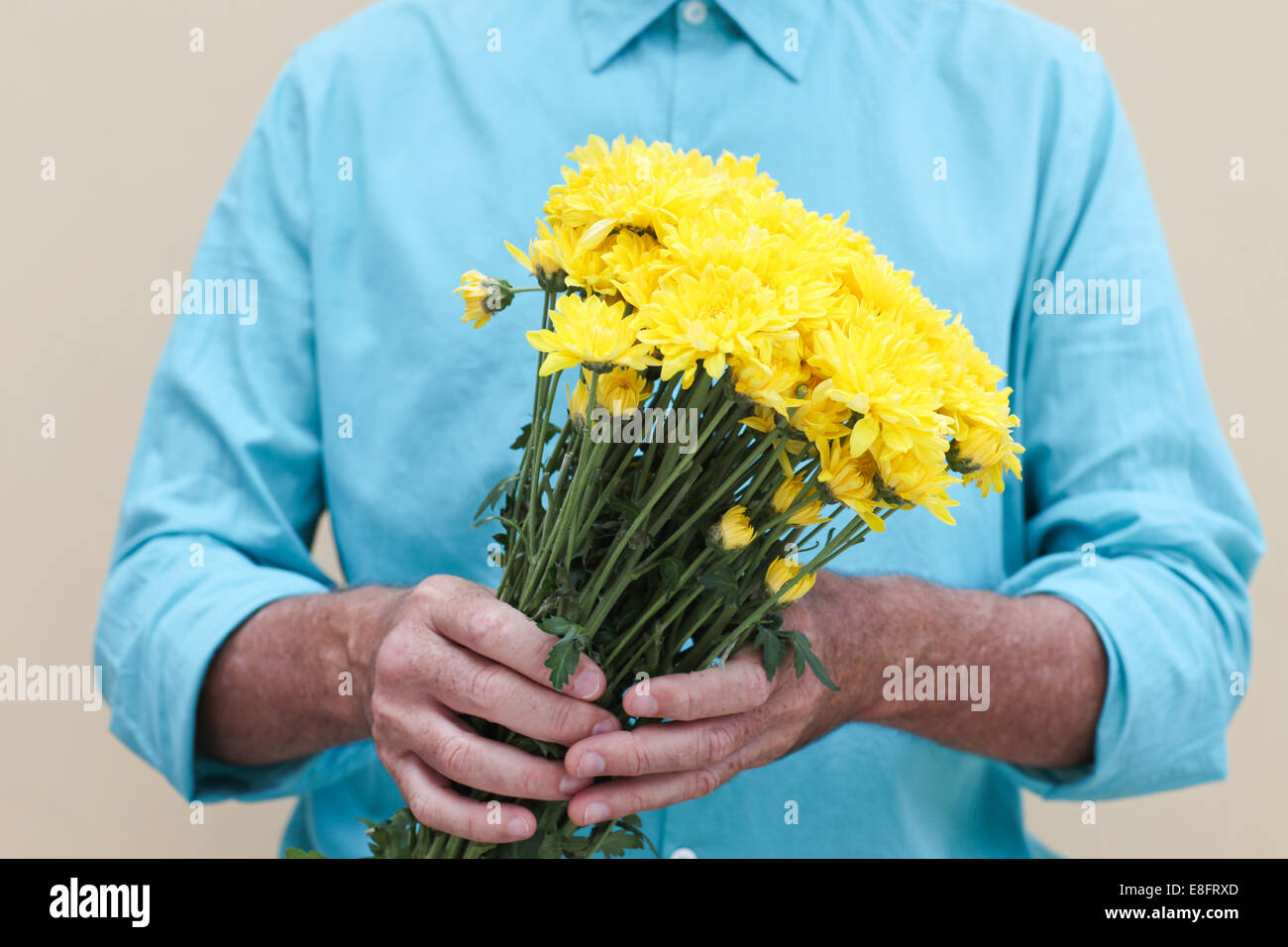Man holding bunch of flowers Stock Photo