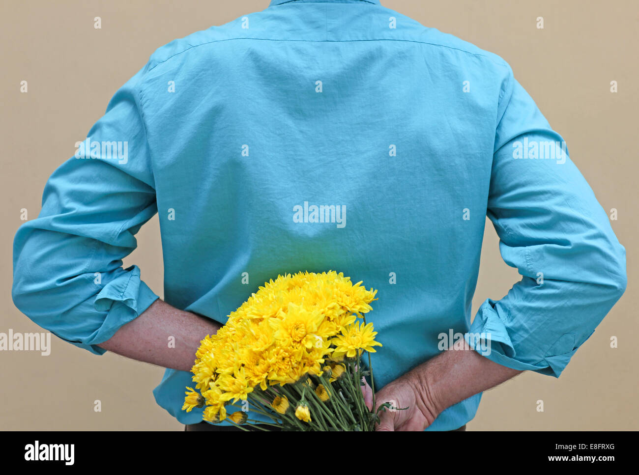 Man Holding Flowers Behind Back