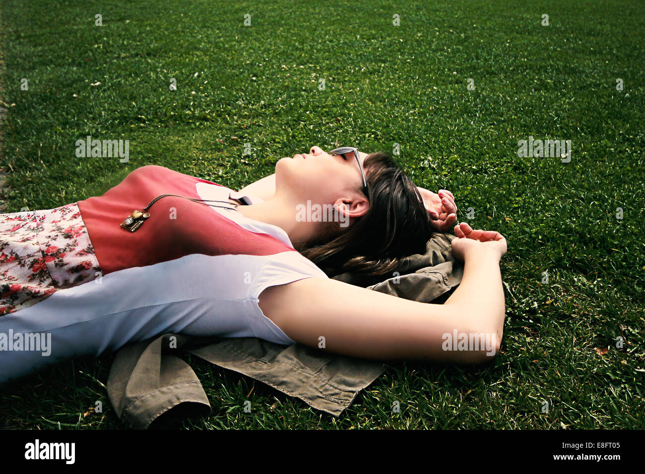 woman lying on grass relaxing Stock Photo