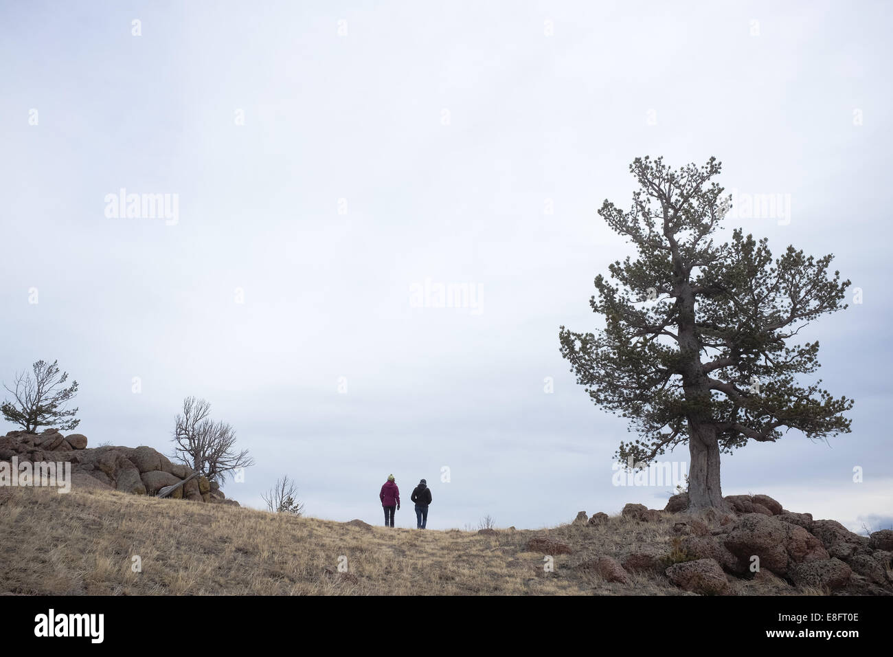 USA, Wyoming, Couple walking on mountain Stock Photo