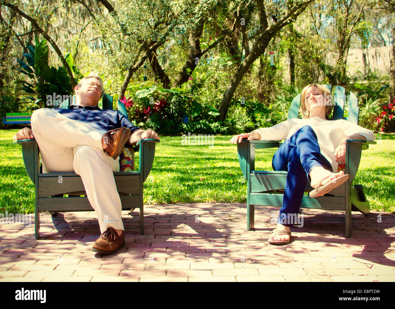 Mature couple sitting in garden chairs Stock Photo