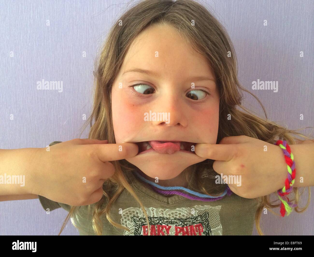 Portrait of a cross-eyed girl pulling funny faces Stock Photo