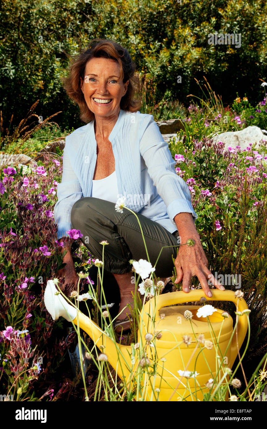 Smiling senior woman gardening in her garden Stock Photo - Alamy