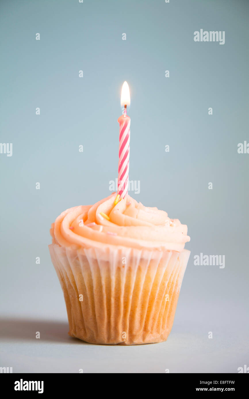 Cupcake with candle Stock Photo - Alamy