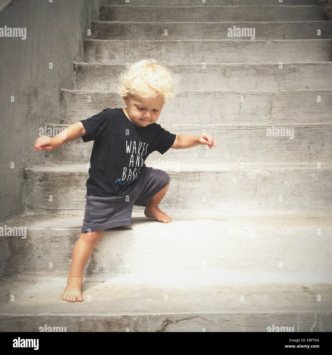 boy walking down steps Stock Photo