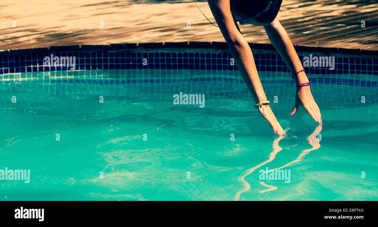 Girl diving into a swimming pool Stock Photo