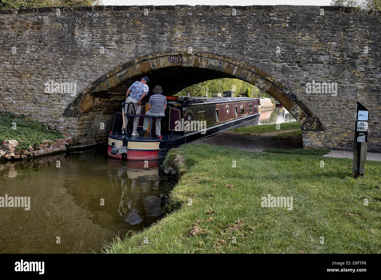 Oxford canal. Narrow boat navigating through the canal bridge on the