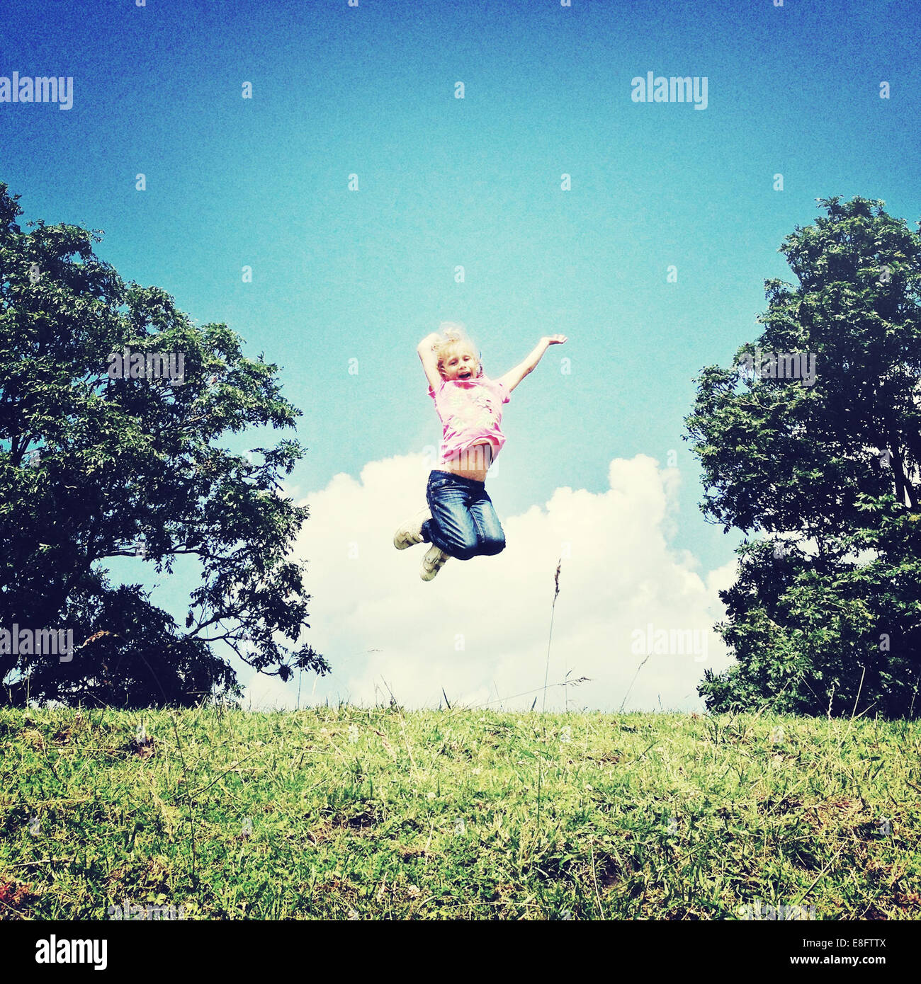 Happy Girl jumping in the air Stock Photo - Alamy