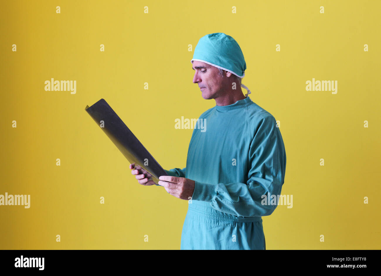 Surgeon looking at x-ray Stock Photo