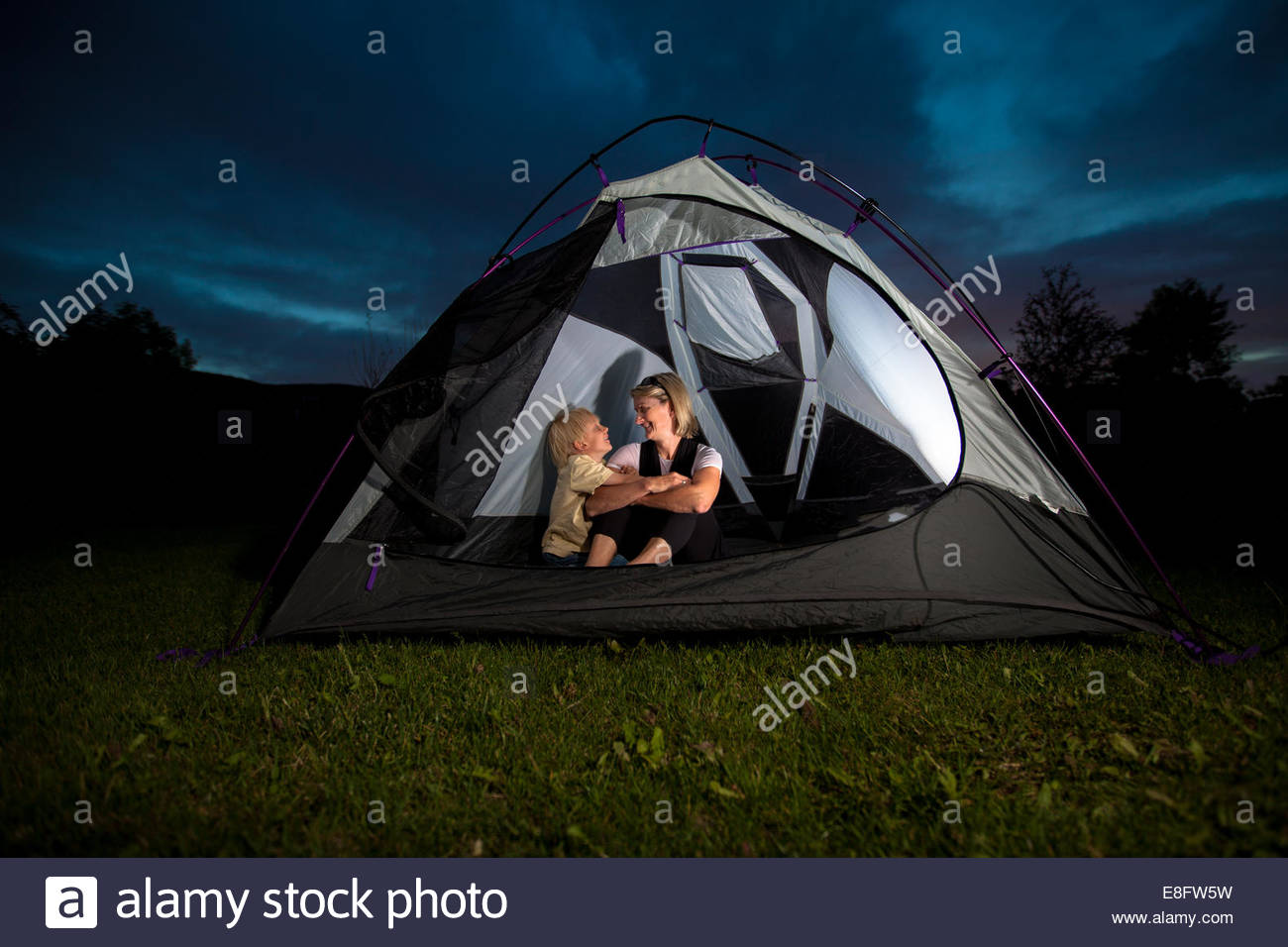 Mother And Son Camping In Tent At Night Stock Photos & Mother And Son