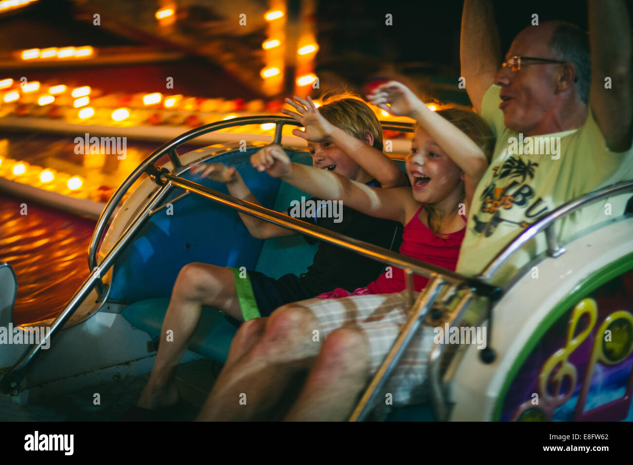 Father and his two children on an amusement rid, Ocean City, New Jersey, USA Stock Photo
