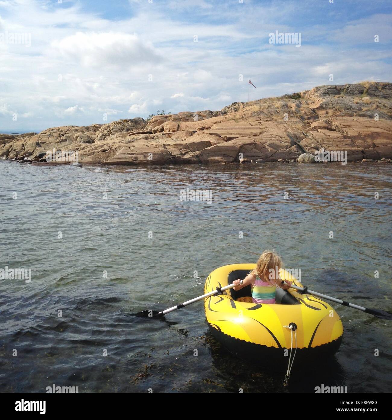 Girl in a dinghy rowing, Norway Stock Photo