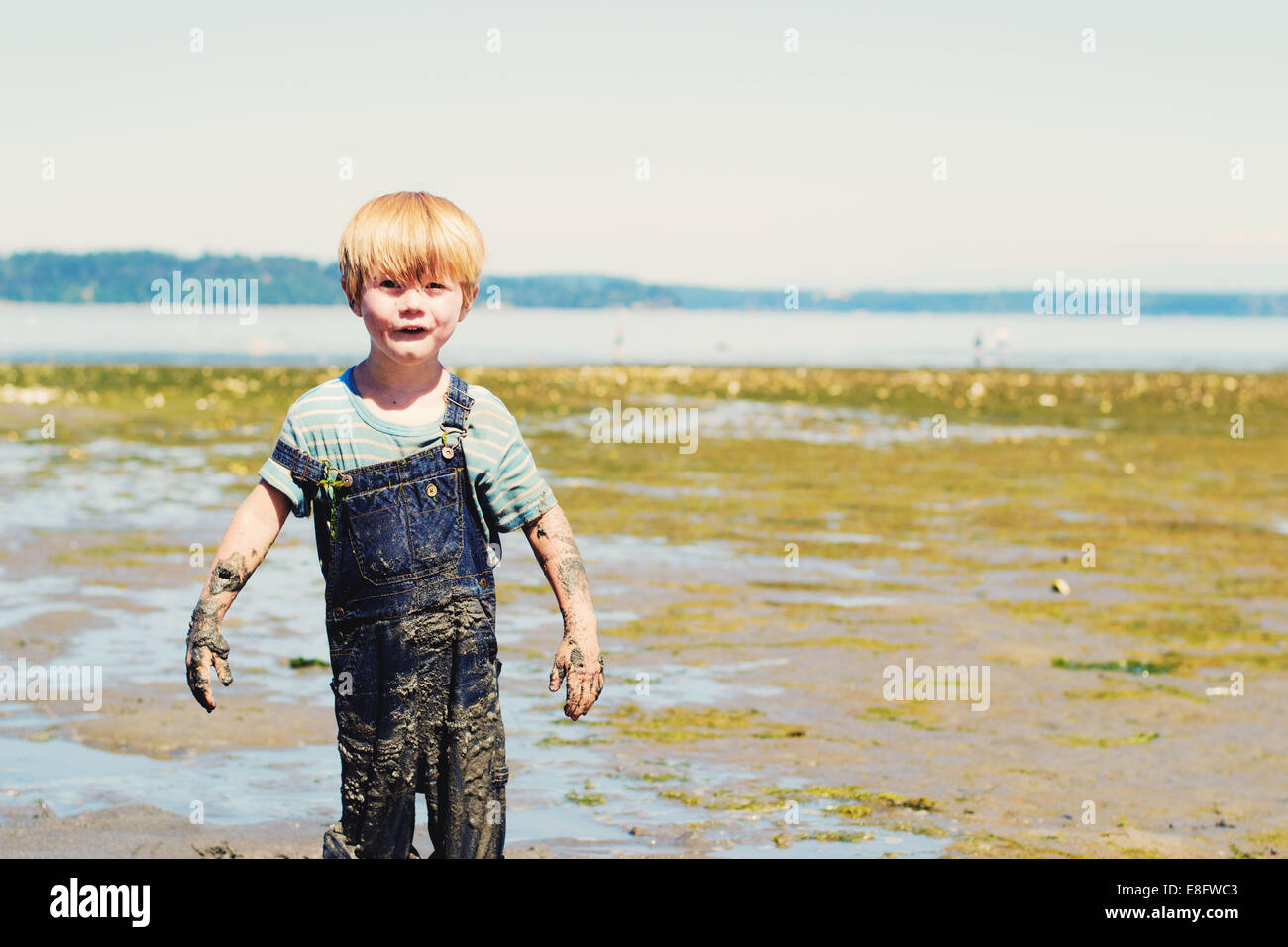 Boy covered in mud (4-5 years) Stock Photo