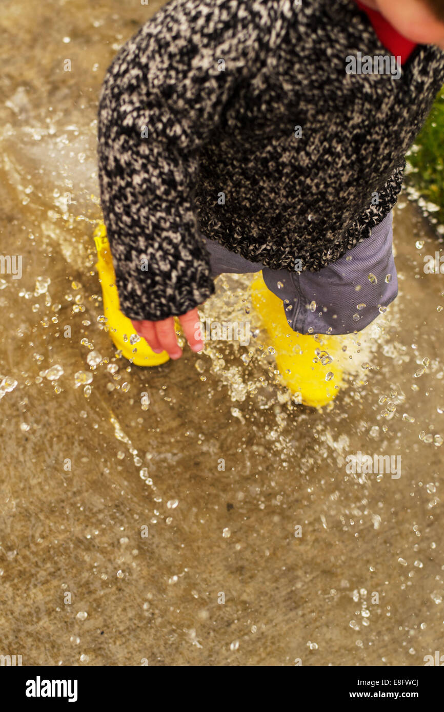 Boy jumping in puddle hi-res stock photography and images - Alamy