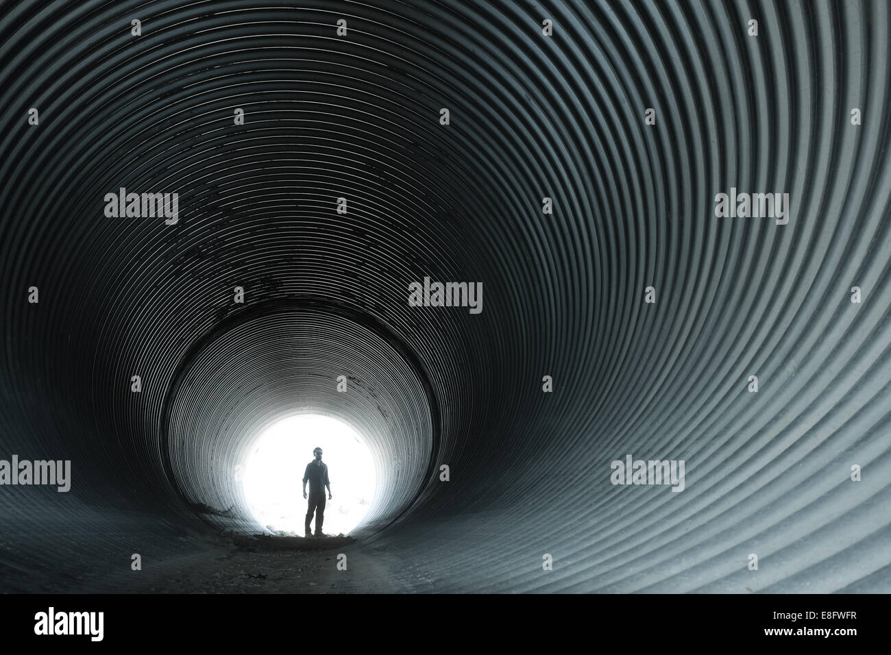 USA, Wyoming, Silhouette of man in circular tunnel Stock Photo